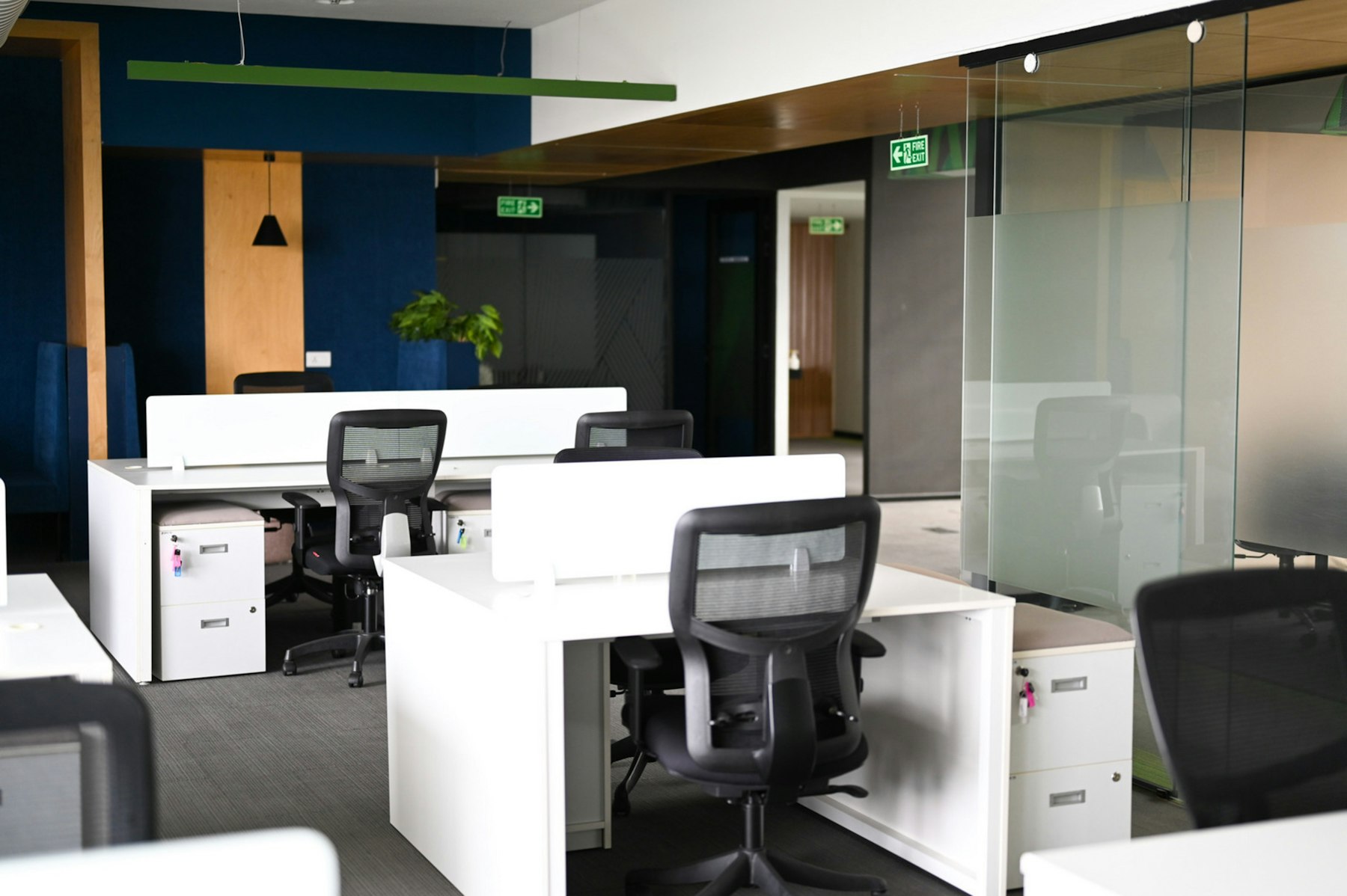 Modern office workstations with desks and chairs