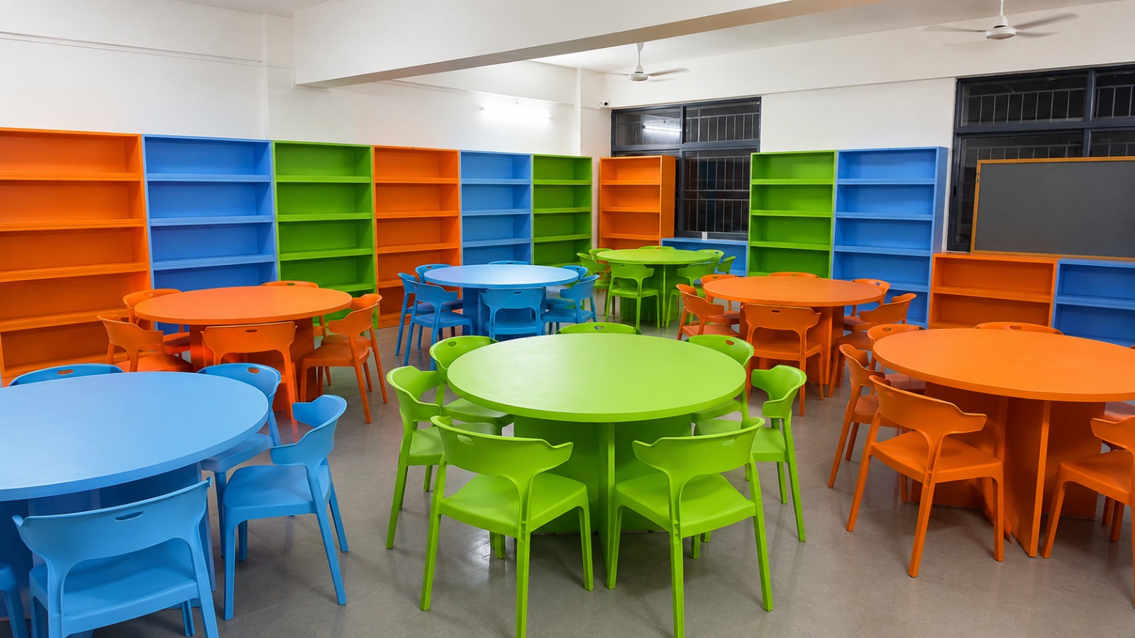 Colourful classroom tables, chairs and coordinated shelving
